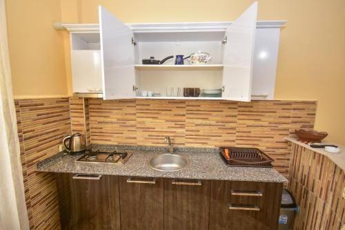 a kitchen with a sink and a counter top at Family Apartments in Batumi in Batumi
