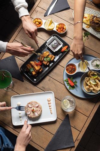a group of people sitting around a table with food at Pullman Mazagan Royal Golf & Spa in El Jadida