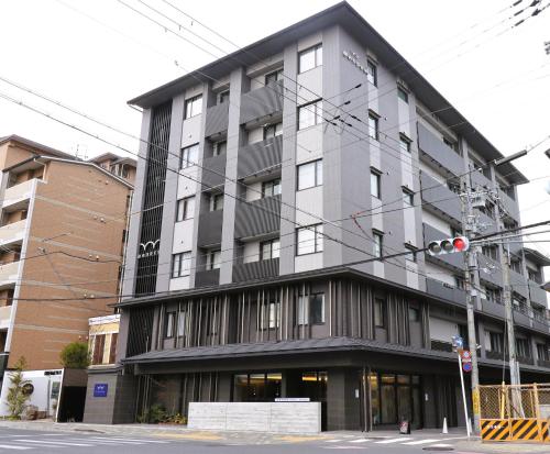 a building on a street corner with a traffic light at Wander Kyoto Nanajo in Kyoto