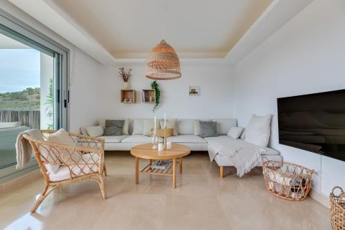 a living room with a couch and a table and chairs at Avalon in Benahavís