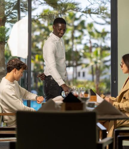 a group of people sitting around a table at Pullman Mazagan Royal Golf & Spa in El Jadida