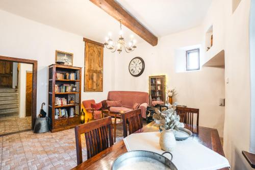 a living room with a table and chairs and a clock at Penzion U náměstí - At the Town Square in Český Krumlov