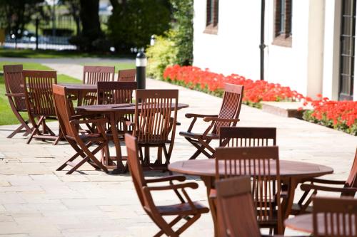 a row of wooden chairs sitting in front of a patio at Western House Hotel in Ayr