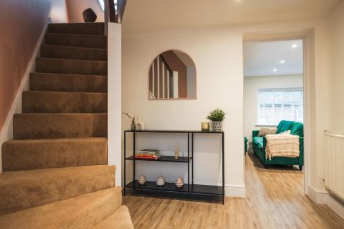 a living room with a staircase and a couch at Feature Stone, Stunning Apartment, 2 x King Beds and Single, Sleeps 5 in Castle Cary