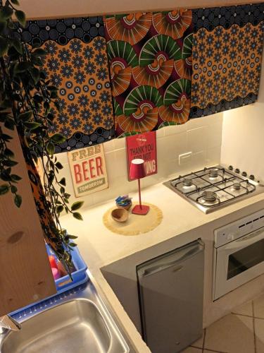 a kitchen with a sink and a stove top oven at Appartamento Alma de Cri 10b, Sal Rei Estoril in Sal Rei