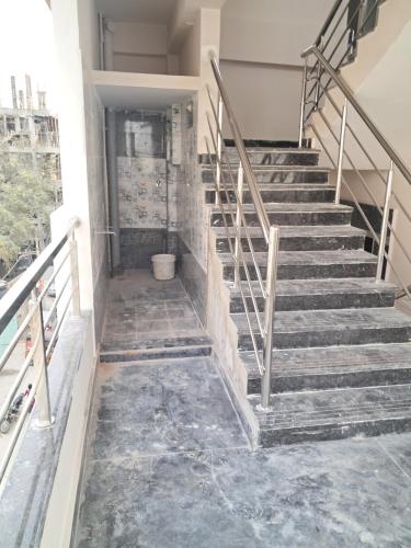 a set of stairs in a building with concrete floors at Srinivasa Nilayam in Hyderabad
