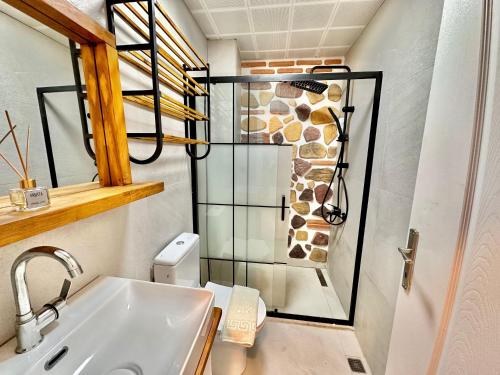 a bathroom with a sink and a glass shower at Zen house in Kas