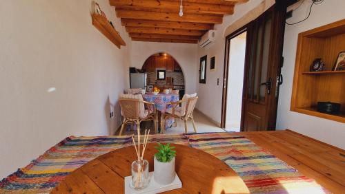 a room with a table and a dining room at Yiannis Village house in Asklipiḯon