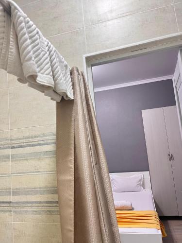 a bedroom with a bed with a curtain at Мини-гостиница Береке in Aktobe
