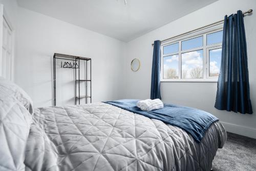 a bedroom with a large bed and a window at The Cosgrove - Central Cleethorpes in Cleethorpes