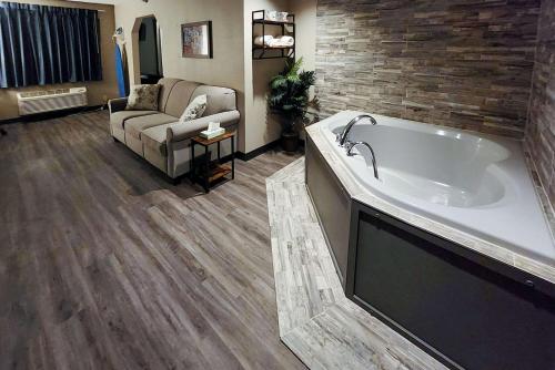 a large bath tub in a living room with a couch at Econo Lodge in Ortonville