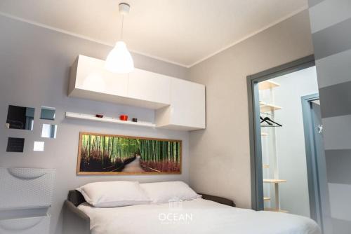 a bedroom with a bed and a painting on the wall at GoldenSuitesItaly I Trento Suite 1 & Garage Privato in Trento