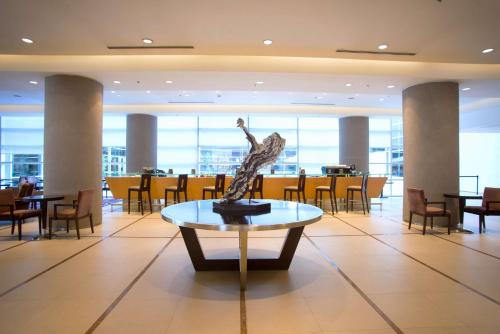 a statue of a woman on a table in a restaurant at Hilton Mendoza in Mendoza