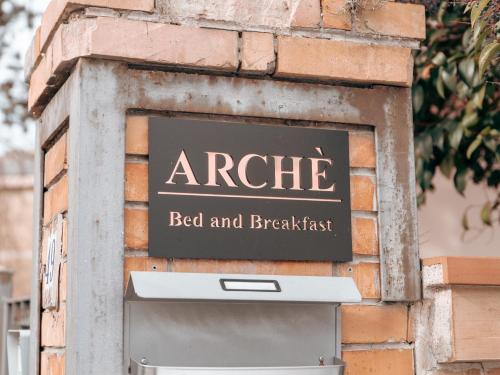 a sign on the side of a brick wall with a bed and breakfast mailbox at Arche' Bed and Breakfast in Matera