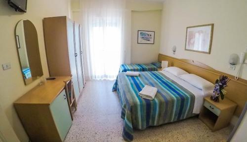 a hotel room with a bed and a mirror at Milano Simple in Bellaria-Igea Marina