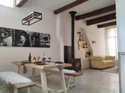 a living room with a table and a fireplace at Maison spacieuse et calme, idéal famille in Perpignan