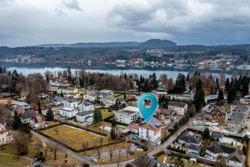 an aerial view of a town next to a lake at Well-Home Apartments Velden in Velden am Wörthersee