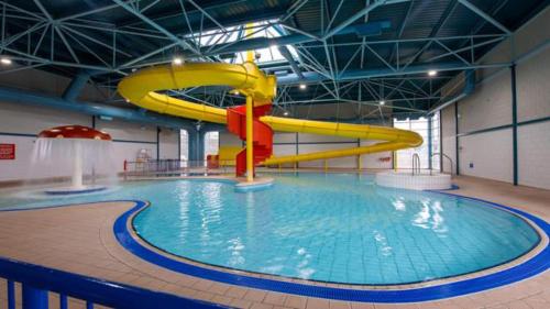 a large swimming pool with a water slide at Beautiful Static Caravan Hoburne Devon Bay in Paignton