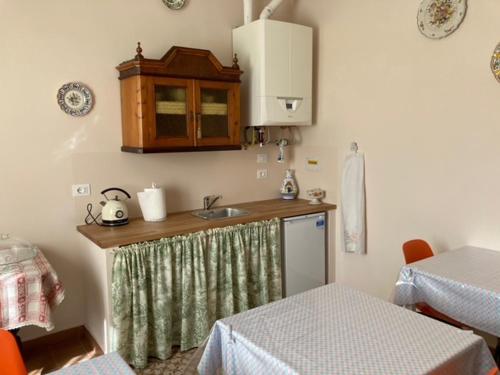 a kitchen with a sink and a counter top at Maison Country B&B in Bologna