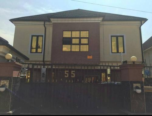 a house with a fence and a house with a score at The Resident Hotel in Owerri
