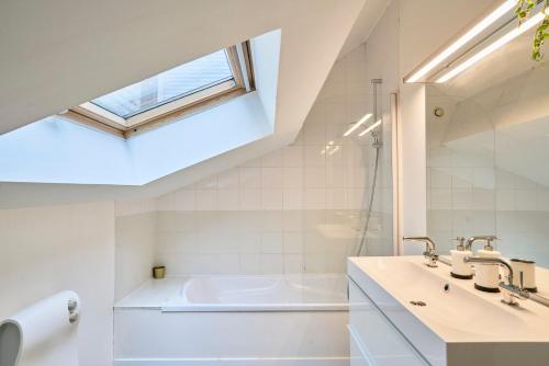 une salle de bain avec un lavabo et une baignoire dans l'établissement 4 bedroom apartment with parking !, à Lille