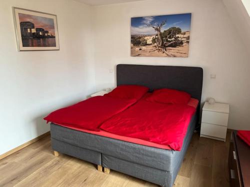 a bed in a room with a red blanket on it at Exklusives Penthouse (72qm) - mit Terrasse im Zentrum in Cologne