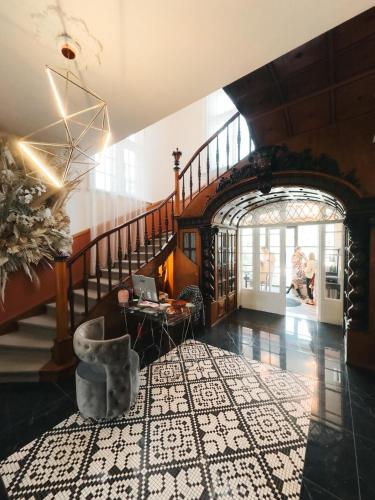 a lobby with a staircase with a table and a laptop on it at Nest in Győr