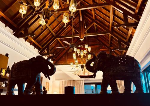 two elephant statues in a room with a ceiling at Villa Kaz' Grenadine in Bel Ombre