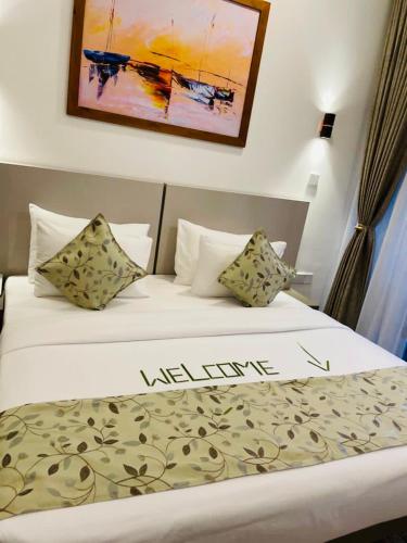 a hotel room with a bed with a welcome sign on it at Blue Wild - Yala - Plastic Free & Sustainable in Tissamaharama