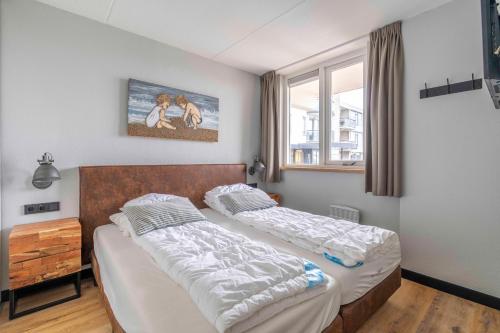 una camera con due letti e una finestra di Appartementencomplex Juliana 44 a De Koog