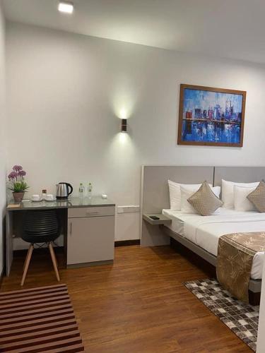a hotel room with a bed and a desk with a desk at Blue Wild - Yala - Plastic Free & Sustainable in Tissamaharama