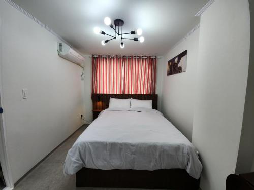 a bedroom with a bed and a ceiling fan at LaonHajae in Seoul