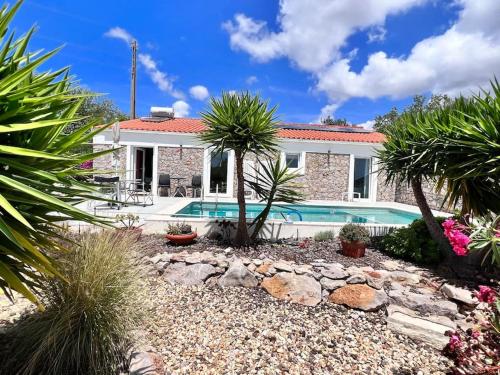 a house with a swimming pool in a yard at Typical quiet Algarve cottage in Faro