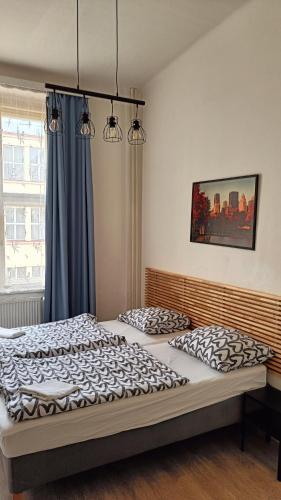 two twin beds in a bedroom with a window at A Plus Hostel - Centrum in Prague