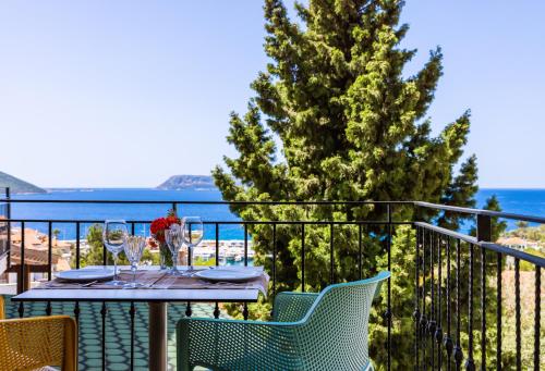 a table on a balcony with a view of the ocean at Luna Kaş in Kas