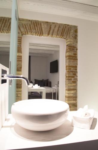 a bathroom with a white bowl sink on a counter at Residenza Amblingh in Vasto