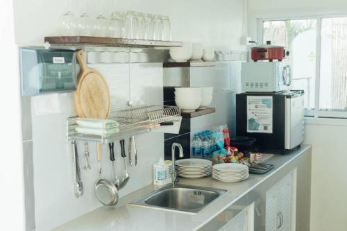 a kitchen with a sink and a counter with dishes at S Money in Rong Sak