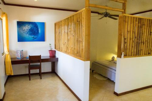 
a room with a wooden floor and a wooden wall at Greenyard Inn in Boracay
