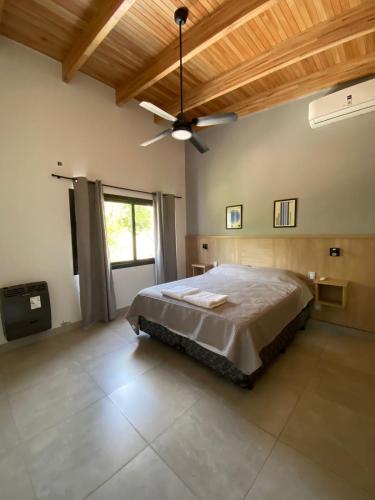 a bedroom with a bed and a ceiling fan at Apart Elisa in Villa Elisa