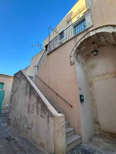 a building with a staircase next to a building at Cavour69 in Avola