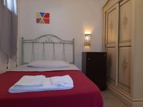 a bedroom with a bed with two towels on it at Villa Mediterranea in Torre dell'Orso