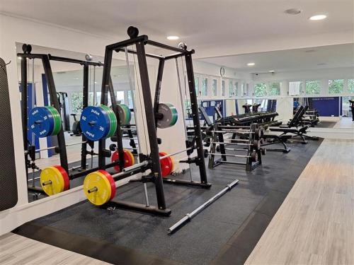 a gym with several treadmills and weights at Greenlands Hotel in Henley on Thames