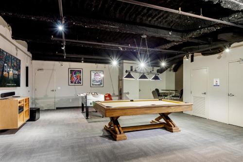 a large room with a pool table in it at Charming California Condos - Near it All in New Orleans