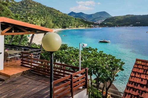 a view of a beach with a boat in the water at Villa Fleur D'eau in Grande Anse