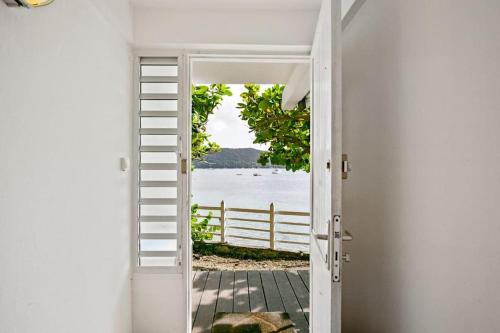 an open door with a view of the water at Villa Fleur D'eau in Grande Anse
