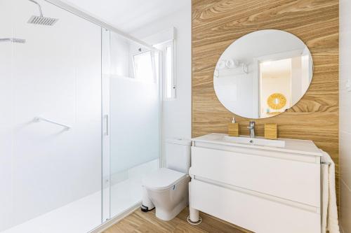 a bathroom with a white sink and a mirror at The Beach -Villa Mar- in Bolnuevo