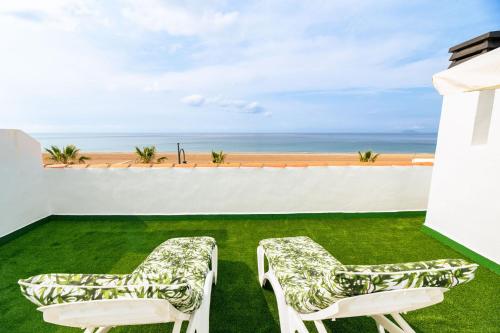 two chairs on a lawn with a view of the ocean at The Beach -Villa Mar- in Bolnuevo