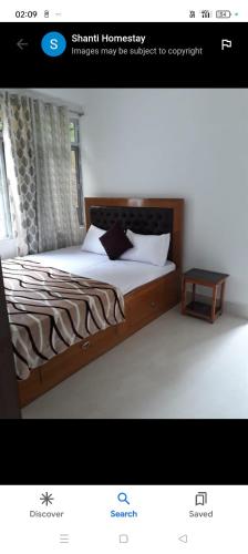 a picture of a bedroom with a bed and a table at Shanti homestay in Temi