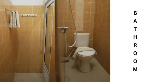 a bathroom with a toilet and a shower at Villa Morphosis in Berpodak