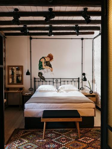 a bedroom with a bed with a painting on the wall at Not Boutique Hotel in Athens